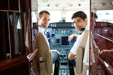 Image showing Pilots In Corporate Plane Cockpit