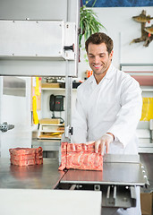 Image showing Butcher Cutting Meat On Bandsaw