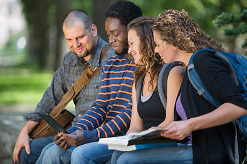 Image showing Students Using Digital Tablet Together On Campus