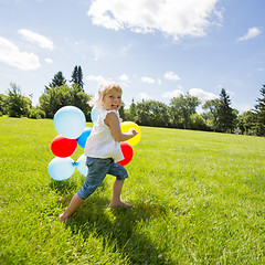 Image showing Girl With Colorful Balloons Running In Meadow