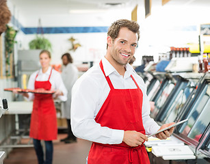 Image showing Portrait Of Happy Butcher Holding Digital Tablet At Store