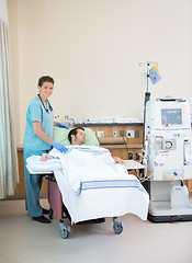 Image showing Portrait Of Nurse Standing By Patient Receiving Dialysis