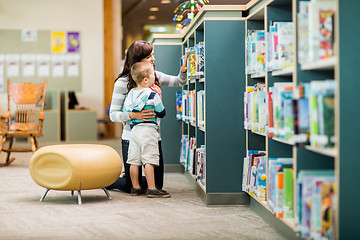Image showing Teacher And Boy Selecting Book In Library