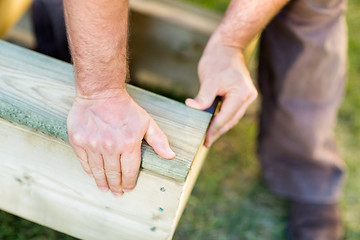 Image showing Manual Worker's Hand Fixing Wood At Site