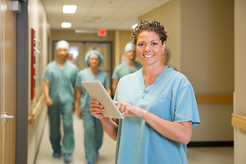 Image showing Surgeon Holding Digital Tablet In Hospital Corridor