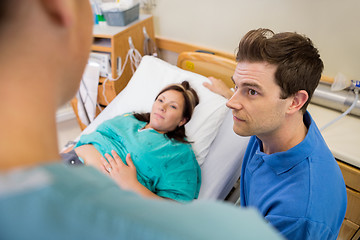 Image showing Man And Pregnant Woman Listening To Nurse In Hospital