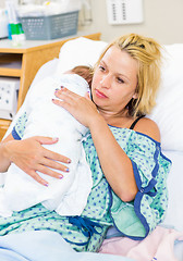 Image showing Woman With Baby Resting On Her Shoulder In Hospital