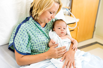 Image showing Woman Looking At Babygirl On Hospital Bed