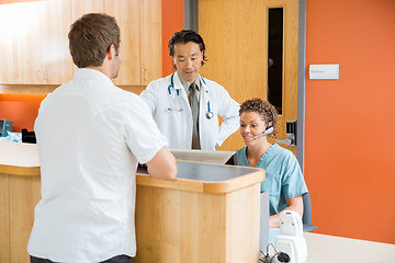 Image showing Doctor And Nurse Working While Man Standing In Hospital