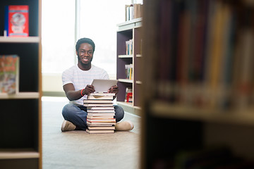 Image showing Student With Books And Digital Tablet Sitting In Library