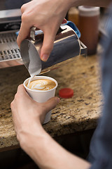 Image showing Barista Making Design On Cappuccino In Coffeeshop