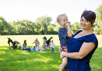 Image showing Happy Mother Carrying Son In Park