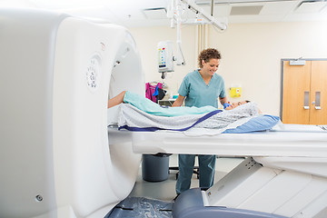 Image showing Nurse Looking At Patient Undergoing CT Scan Test