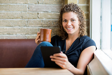 Image showing Woman Using Digital Tablet In Cafe