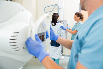 Image showing Nurse Adjusting Xray Machine In Examination Room