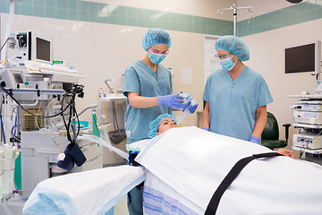 Image showing Nurse Adjusting Oxygen Mask On Patient