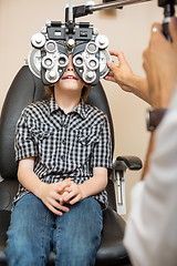 Image showing Boy Undergoing Eye Examination With Phoropter