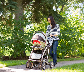 Image showing Woman Pushing Baby Carriage In Park