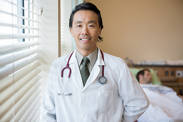 Image showing Confident Doctor With Patient At Hospital Room