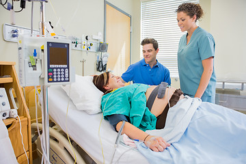 Image showing Happy Man And Nurse Looking At Pregnant Woman