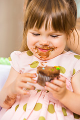 Image showing Girl Eating Birthday Cake With Icing On Her Face