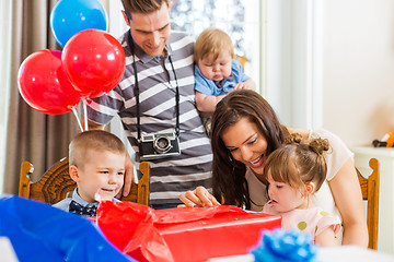 Image showing Family Opening Birthday Present At Home