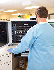 Image showing Lab Tech Working with Hematology Analyzer