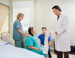 Image showing Doctor Explaining Fetal Monitor Report To Pregnant Woman