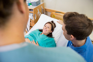 Image showing Pregnant Woman Looking At Nurse By Husband In Hospital