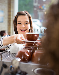 Image showing Customer Taking Coffee From Waitress In Cafe