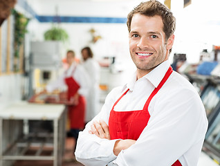 Image showing Happy Butcher Standing Arms Crossed At Store