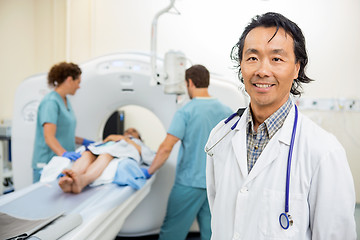 Image showing Radiologist With Nurses Preparing Patient For CT Scan