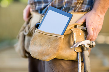 Image showing Digital Tablet And Hammer In Carpenter's Tool Belt