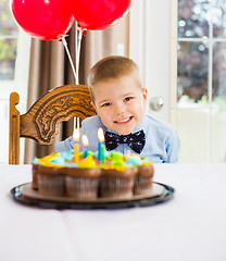 Image showing Happy Boy Sitting In Front Of Birthday Cake