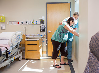 Image showing Nurse Comforting Tensed Pregnant At Window In Hospital Room