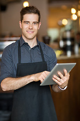 Image showing Male Owner Holding Digital Tablet In Cafeteria