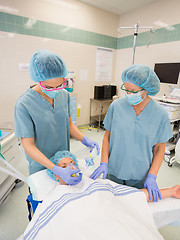 Image showing Nurses Adjusting Oxygen Mask On Female Patient