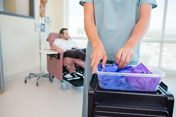 Image showing Detail of Nurse Taking Gloves in Chemo Department