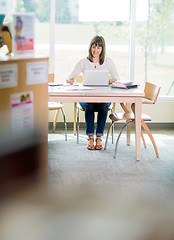 Image showing Student With Laptop Writing Notes In Library