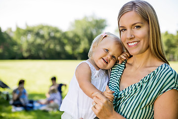 Image showing Happy Mother Carrying Cute Daughter In Park