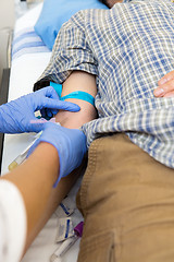 Image showing Doctor Drawing Blood From Patient's Arm