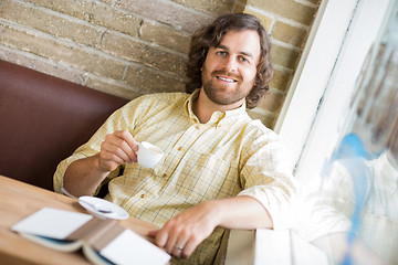 Image showing Man With Coffee Cup And Book In Cafe