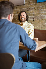 Image showing Man With Friend Sitting At Coffeeshop