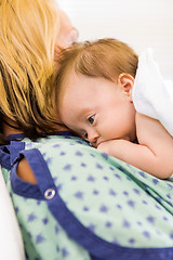 Image showing Cute Babygirl Lying On Mother In Hospital