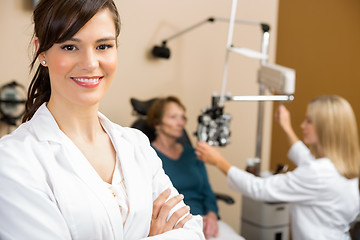 Image showing Female Optometrist With Colleague Examining Patient