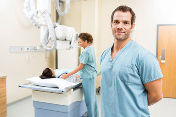 Image showing Nurse With Colleague Preparing Patient For Xray