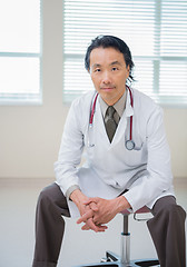 Image showing Doctor With Hands Clasped Sitting In Hospital Room