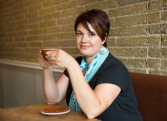 Image showing Smiling Woman Holding Coffee Cup In Cafeteria