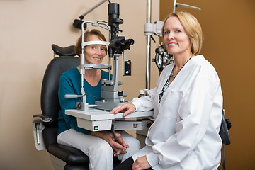 Image showing Optometrist Examining Senior Patient's Eyes