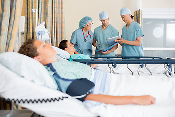 Image showing Nurses Discussing Patient's Chart Post Surgery